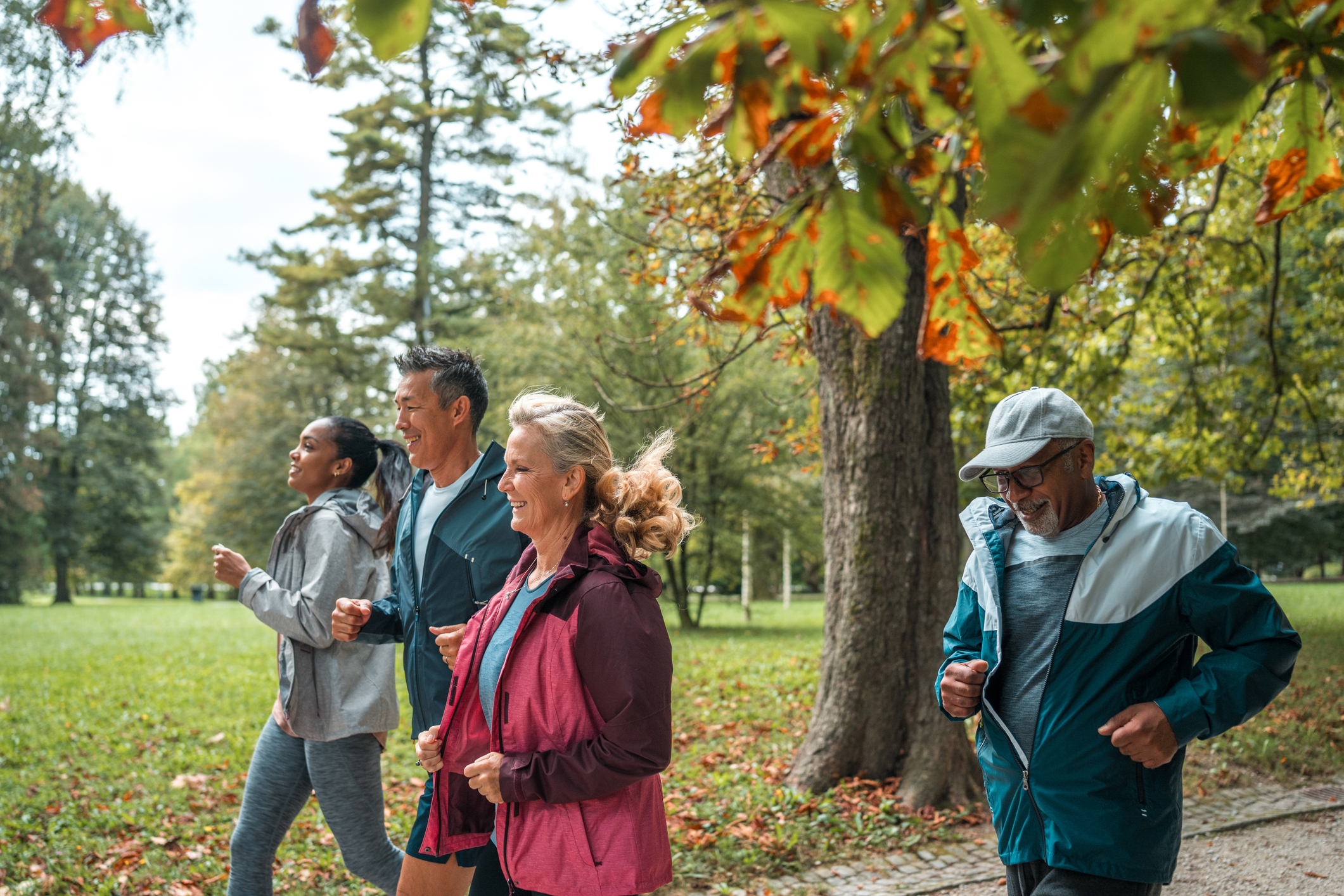 Group of members jogging in a park to reach their wellness goals
